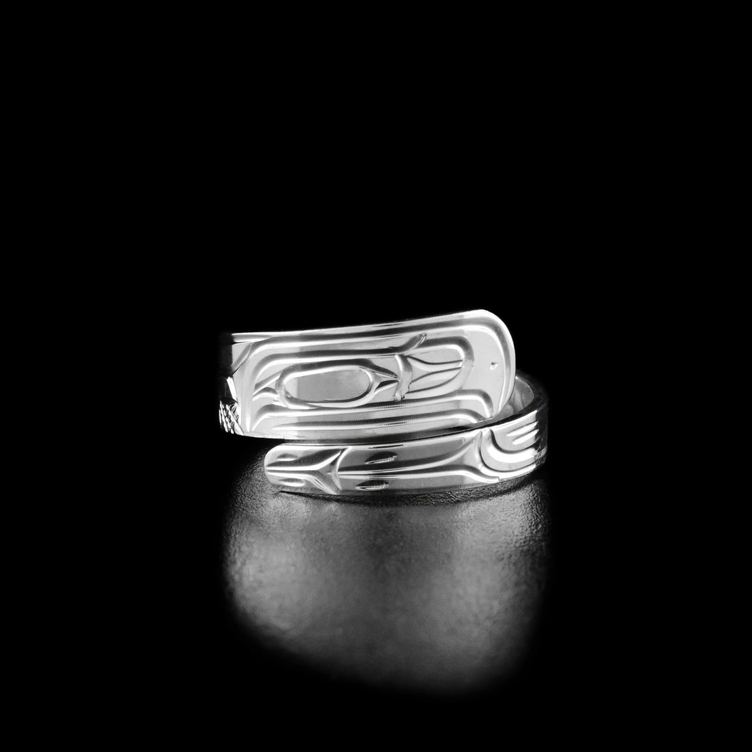 This Raven ring is made from sterling silver and has a tapered band that wraps around the finger twice. There is a depiction of the Raven carved into the surface of the wrap ring.