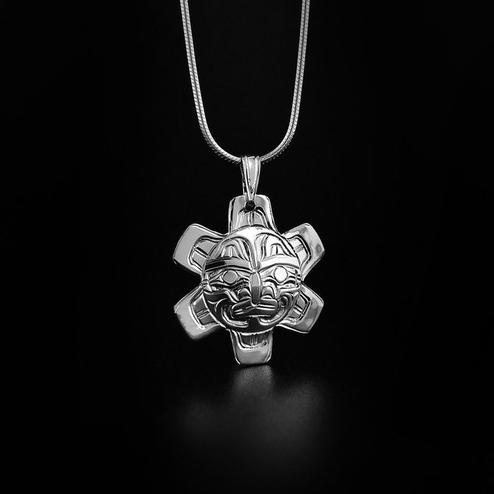 This Sun pendant is made from sterling silver and is shaped like the Sun. There are carvings on the surface of the pendant that depict the Sun.