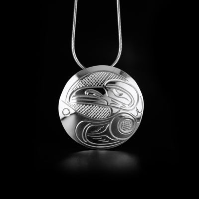 This Round Raven Pendant is handmade by Kwakwaka'wakw artist, John Lancaster, from sterling silver. The pendant measures 1.26" in diameter.  The Raven Legend Represents: CREATIVITY, MISCHIEF, MAGIC.