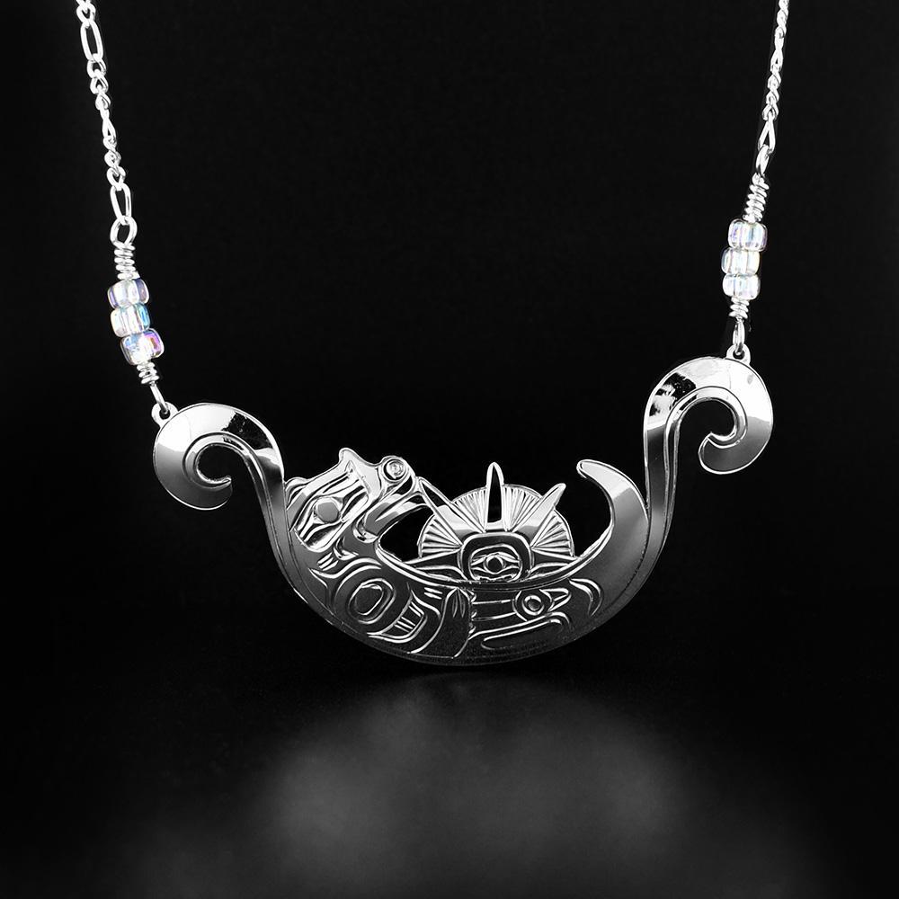 This sea urchin and Otter necklace is made from sterling silver. The pendant has been intricately crafted to depict an Otter on its back holding a sea urchin.