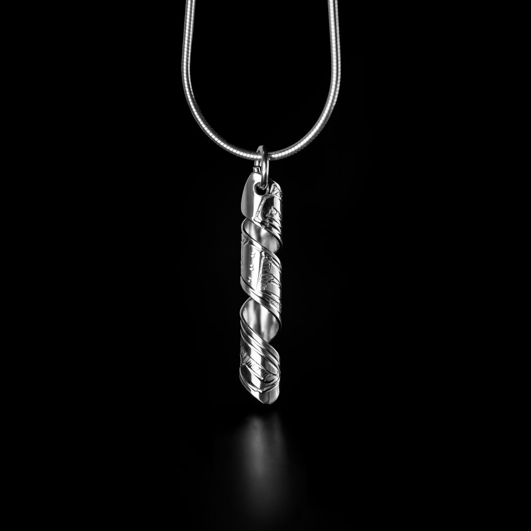 This spiral pendant is made from sterling silver and is a band that has ben coiled into a spiral. The pendant hangs vertically and there are depictions of the Eagle carved into it.