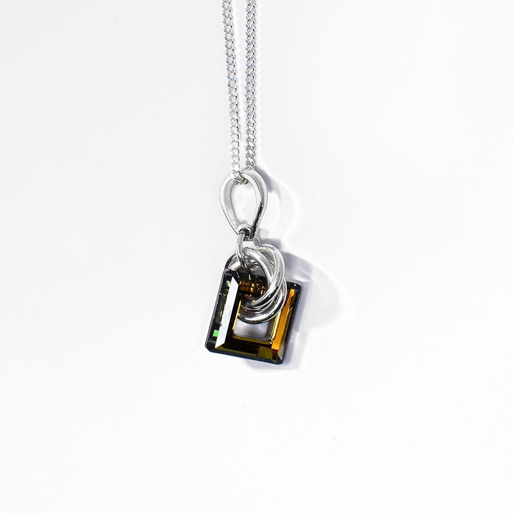 This bronze Swarovski crystal pendant has a square crystal with a cutout in the middle of it. There are many sterling silver hoops linked through the crystal on the chain.