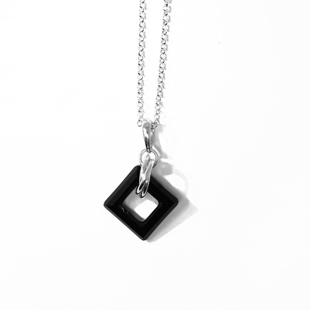 This jet black Swarovski crystal pendant has a square crystal with a cutout in the middle of it. There are many sterling silver hoops linked through the crystal on the chain.