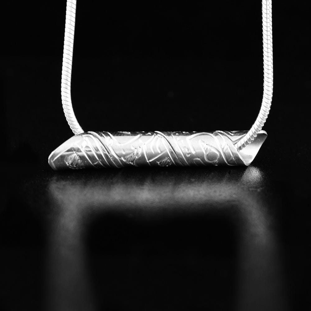 This unique spiral pendant is made from sterling silver and is made from a long band that has been looped four times to create a long spiral. There is a depiction of the Wolf carved into the surface of the pendant.
