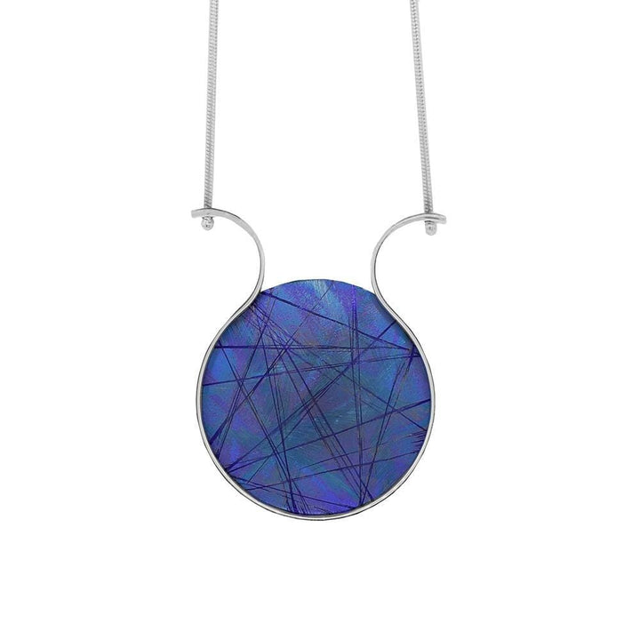 This titanium necklace is made from sterling silver and anodized titanium and has a circle shaped pendant. The circle part of the pnedant is blue and made of titanium, the color and signs on the titanium has been achieved by anodizing it. There are silver wires curved out from the pendant.