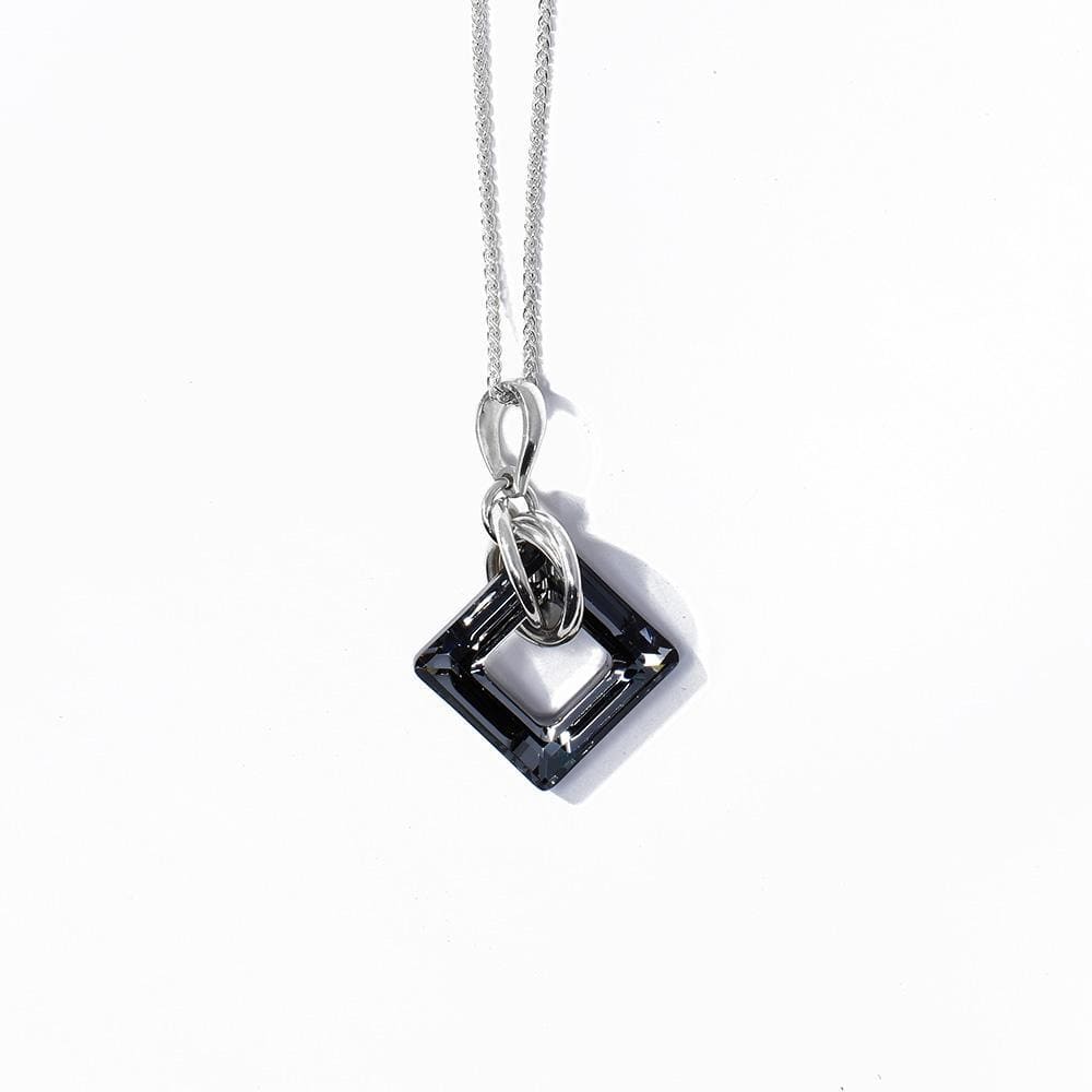 This charcoal Swarovski crystal pendant has a square crystal with a cutout in the middle of it. There are many sterling silver hoops linked through the crystal on the chain.