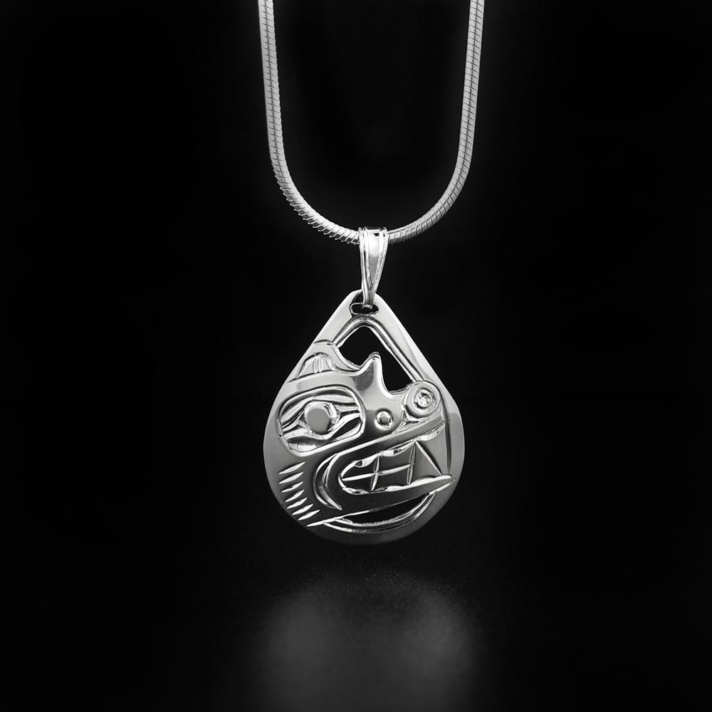 This cutout Bear pendant is made from sterling silver and is teardrop shaped. The pendant has cutouts and carvings on the surface of it that depict the Bear.