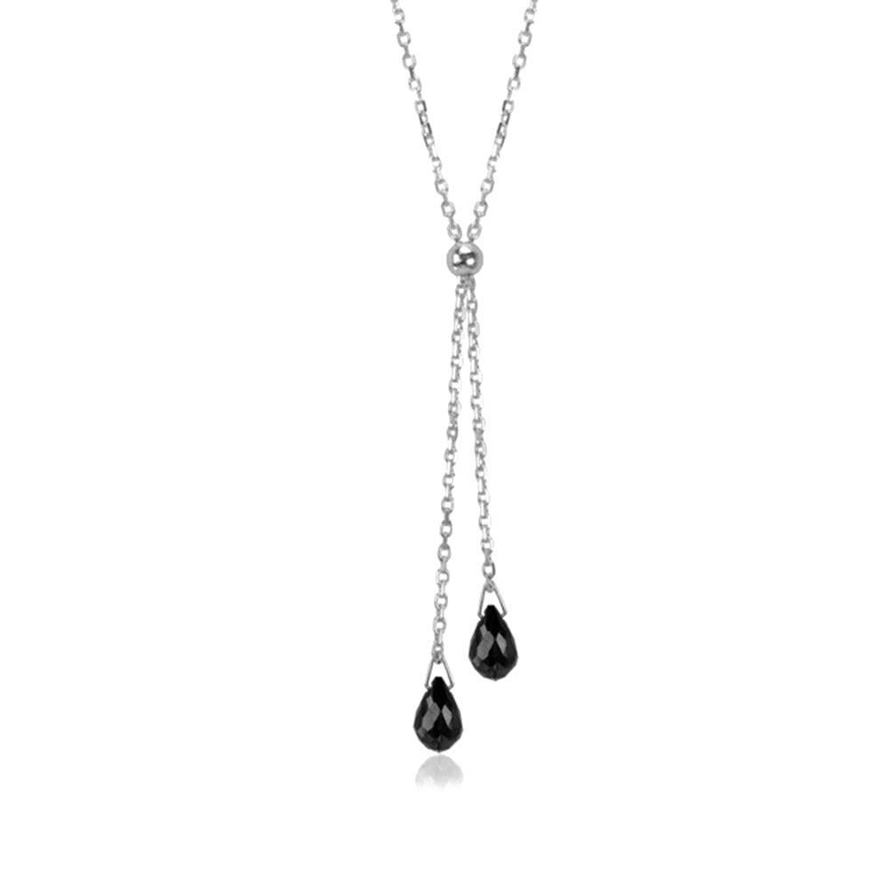 This gemstone lariat necklace is made from sterling silver and rutile quartz. The silver chain is dainty and there are two lariats with teardrop shaped gems at the bottom of them.