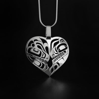 This Cut-Out Orca and Wolf Pendant is by artist, Trevor Angus. The artist has used the laser cut method to make this heart pendant. This sterling silver pendant measures 1.9″ (4.9cm) long. The chain is sold separately. The Orca Legend Represents: LONGETIVITY, PROTECTION, FAMILY. The Wolf Legend Represents: LOYALTY, TEACHER, COOPERATION.