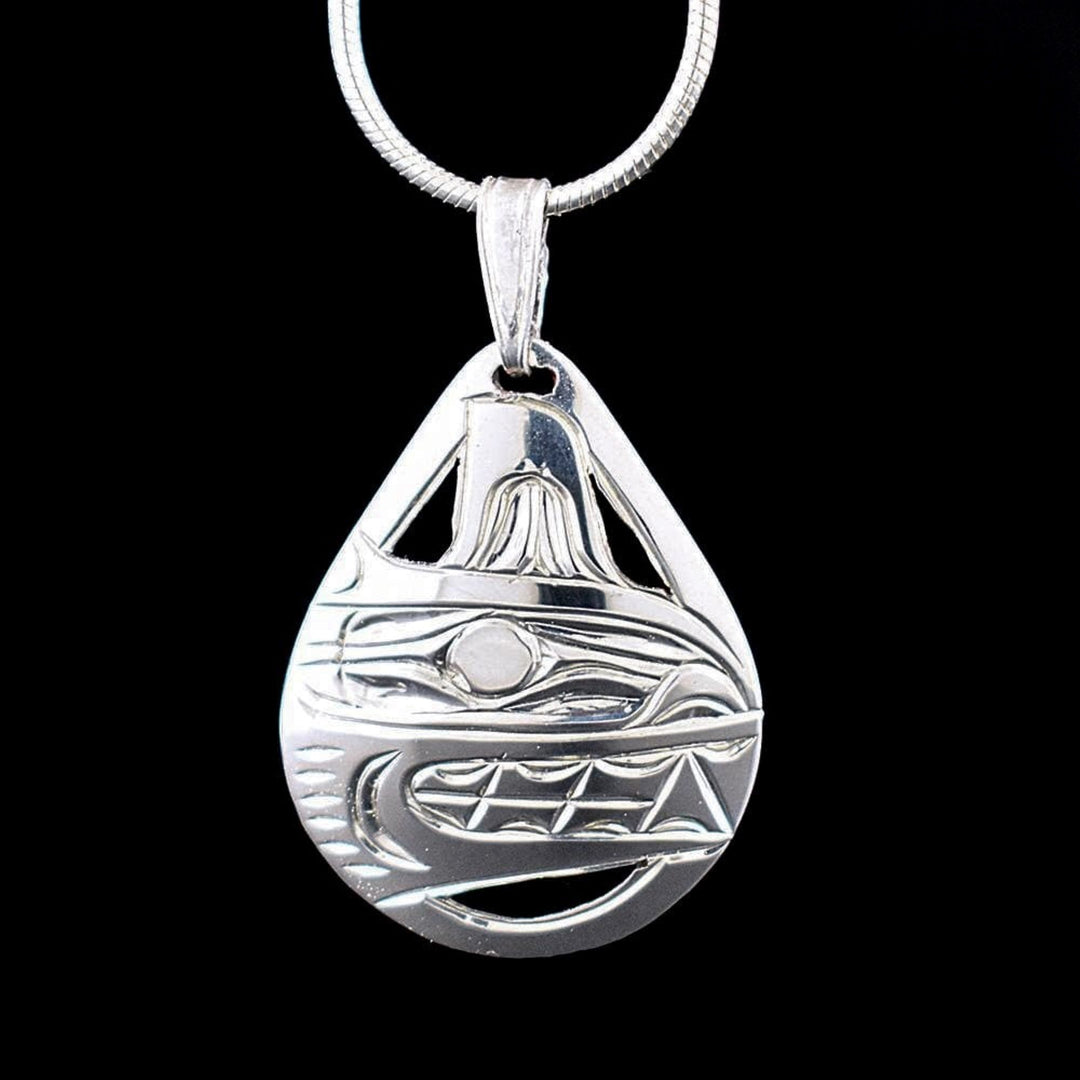 This Orca whale pendant is made from sterling silver and has a tear drop shape to it. There are cutouts and carvings on the surface of it that depict the Orca.