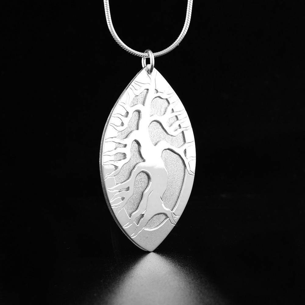 this tree of life pendant is made from sterling silver and has a vertical, oval shaped pendant. There are layered designs on the pendant depicting the tree of life.