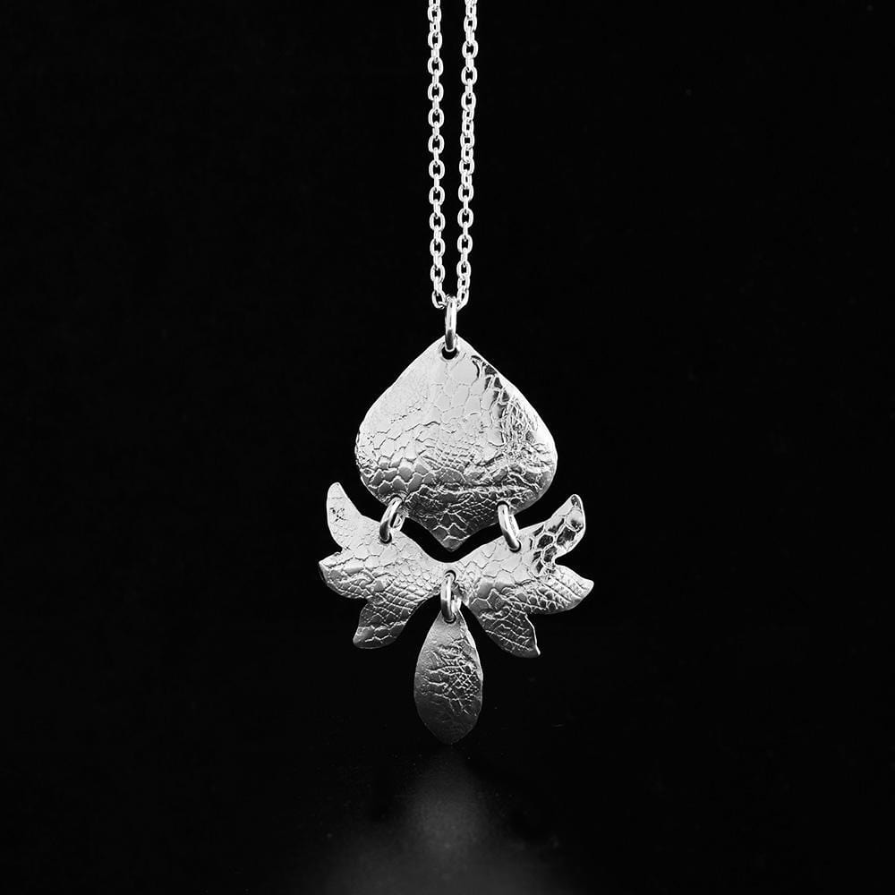 This waratah flower pendant is made from sterling silver and has multiple pieces depicting the flower attached together. They have used French lace to emboss the surface of the piece.