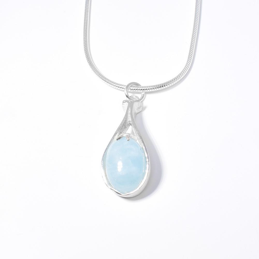 This aquamarine necklace has a pendant made from a beautifully designed sterling silver cradle that holds a large, aquamarine gem.