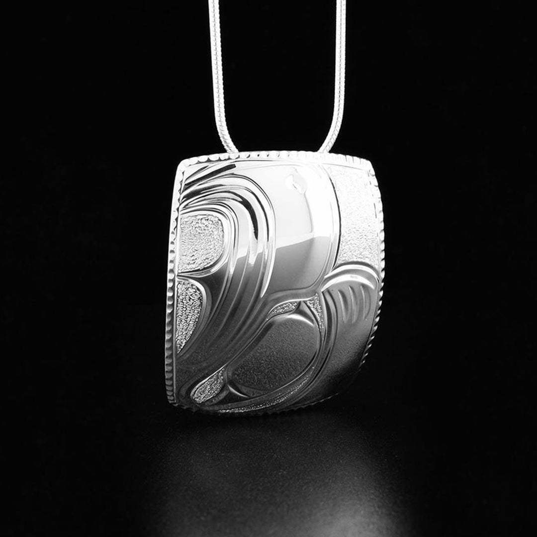 This eagle pendant has the profile of an eagle's head with a pointy beak facing directly upwards.