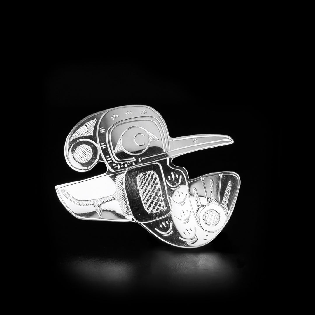 This Hummingbird Shaped Pin is handmade by Coast Salish artist, Gilbert Pat. He has used sterling silver to create this piece. The pin measures approximately 1.85" x 2.0". The Hummingbird Legend Represents: BEAUTY, LOVE, HARMONY.