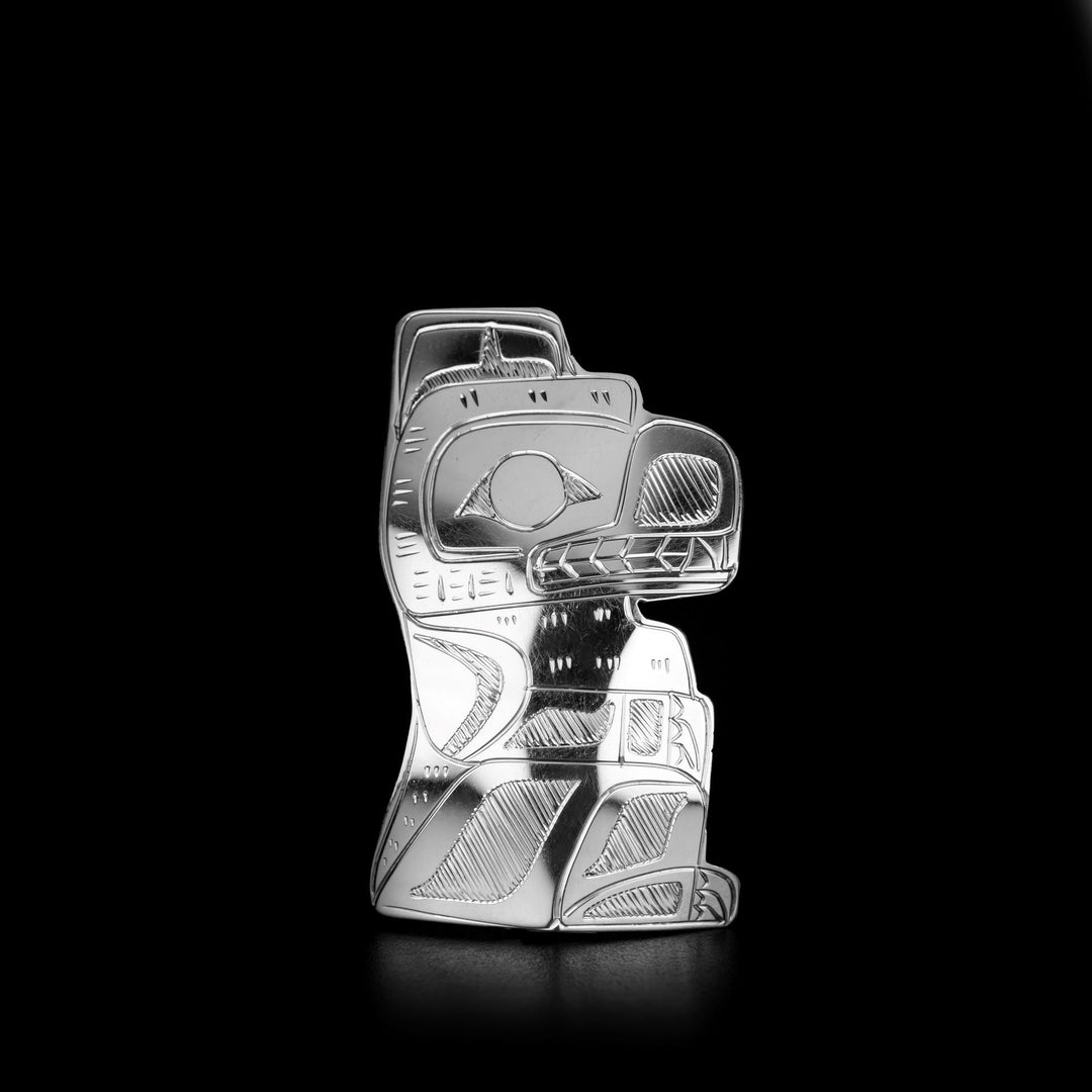 This Bear Shaped Pin is handmade by Coast Salish artist, Gilbert Pat. He has used sterling silver to create this piece. The pin measures approximately 2.0" x 1.18". The Bear Legend Represents: STRENGTH, COURAGE, PARENTHOOD.