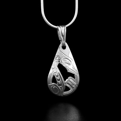 Sterling Silver Teardrop Heron Pendant by Harold Alfred. The design depicts a heron facing down towards some cattails. Parts of the pendant are cut out.