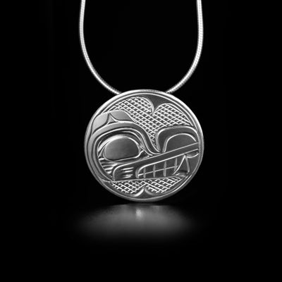 This Round Wolf Pendant is handmade by Kwakwaka'wakw artist, Victoria Harper. She has used sterling silver to create this piece. The pendant measures approximately 1.0" in diameter. There is a hidden bail in the back. The chain is not included. The Wolf Legend Represents: LOYALTY, TEACHER, COOPERATION.