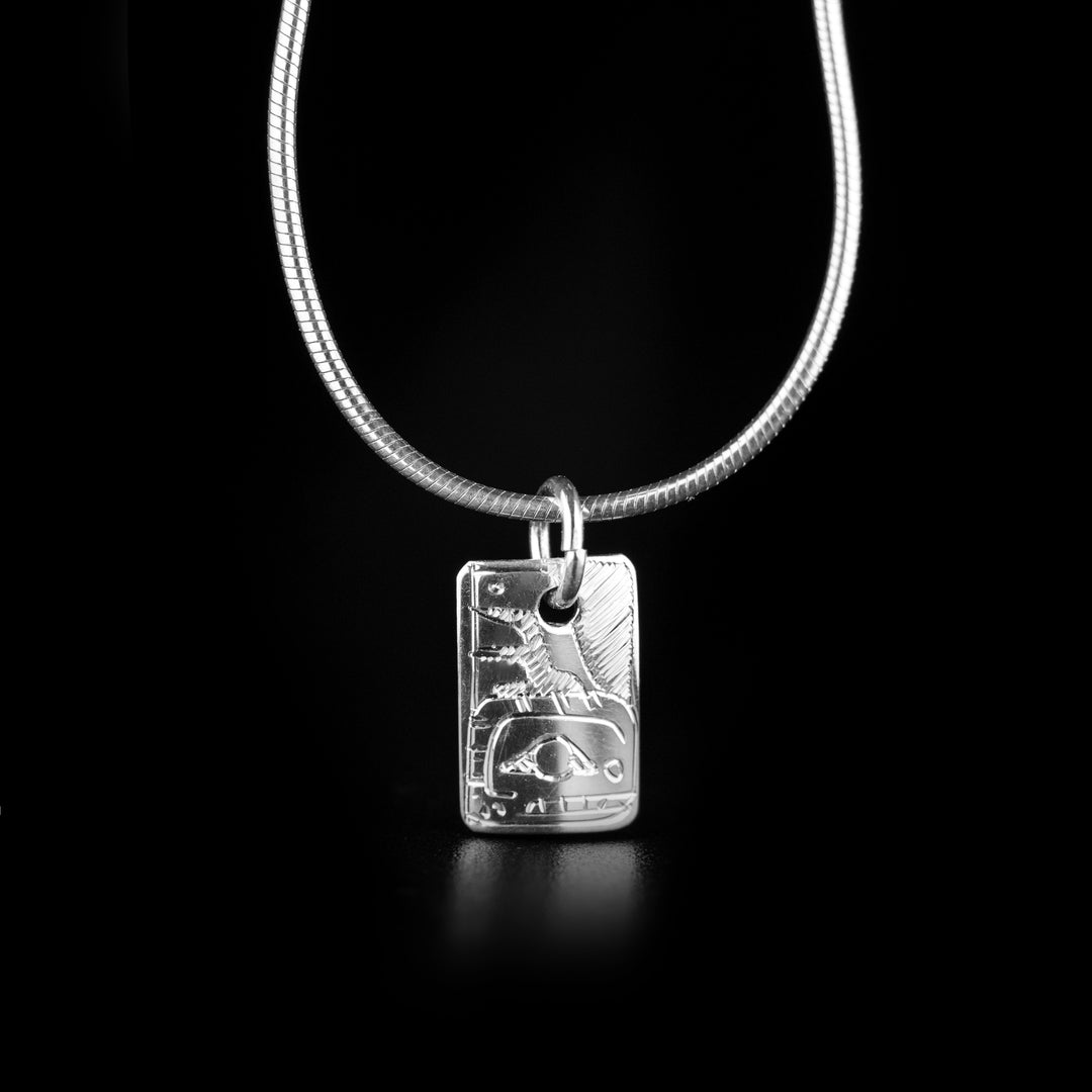 This Sterling Silver Double Orca Pendant is handmade by Coast Salish artist, Gilbert Pat. Both sides of the pendant feature an orca. The pendant measures approximately 0.6" x 0.4" including the bail. The chain is not included. The Orca Legend Represents: LONGEVITY, PROTECTION, FAMILY.