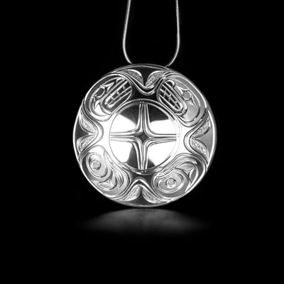 Sterling Silver 2" Round Orca Pendant by Paddy Seaweed. The design depicts the heads of two orcas facing each other at the very top of the pendant with a cross in the center. The artist has created intricate designs along the rest of the pendant.
