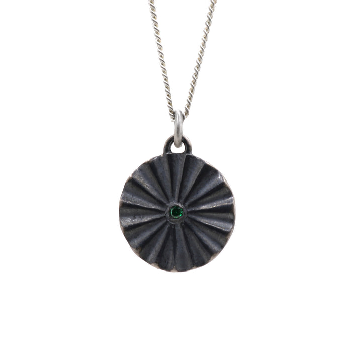Oxidized necklace hanging from its chain.