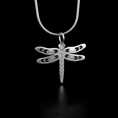 This dragonfly pendant depicts a cut out dragonfly with two wings on both sides. Parts of the wings have been cut out as accents for depth.