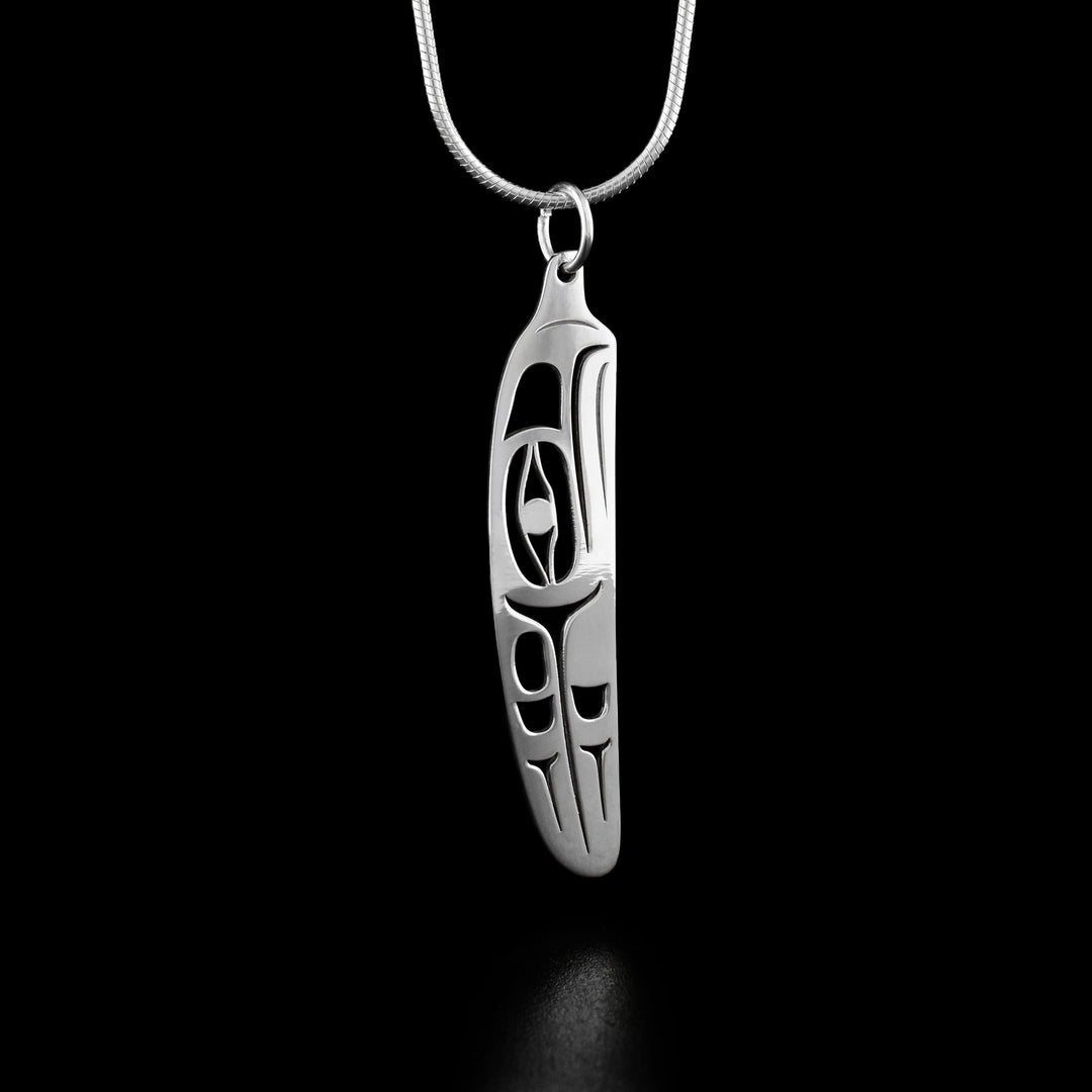 This eagle pendant depicts the profile of an eagle's head with feathers behind the head carved into the feather-shaped pendant.