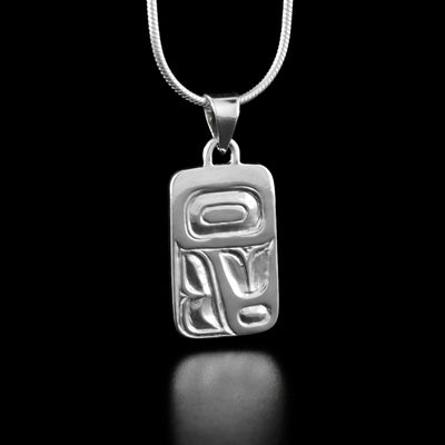 Sterling Silver Feather Cast Pendant by Carrie Matilpi. The design of this pendant appears to be very abstract. At the top there is a large rectangle with another smaller rectangle inside while the bottom of the pendant has feather-like designs in it.