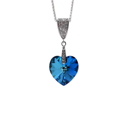 This crystal heart pendant is heart-shaped and blue in colour. It can a long silver bail covered in cubic zirconia.
