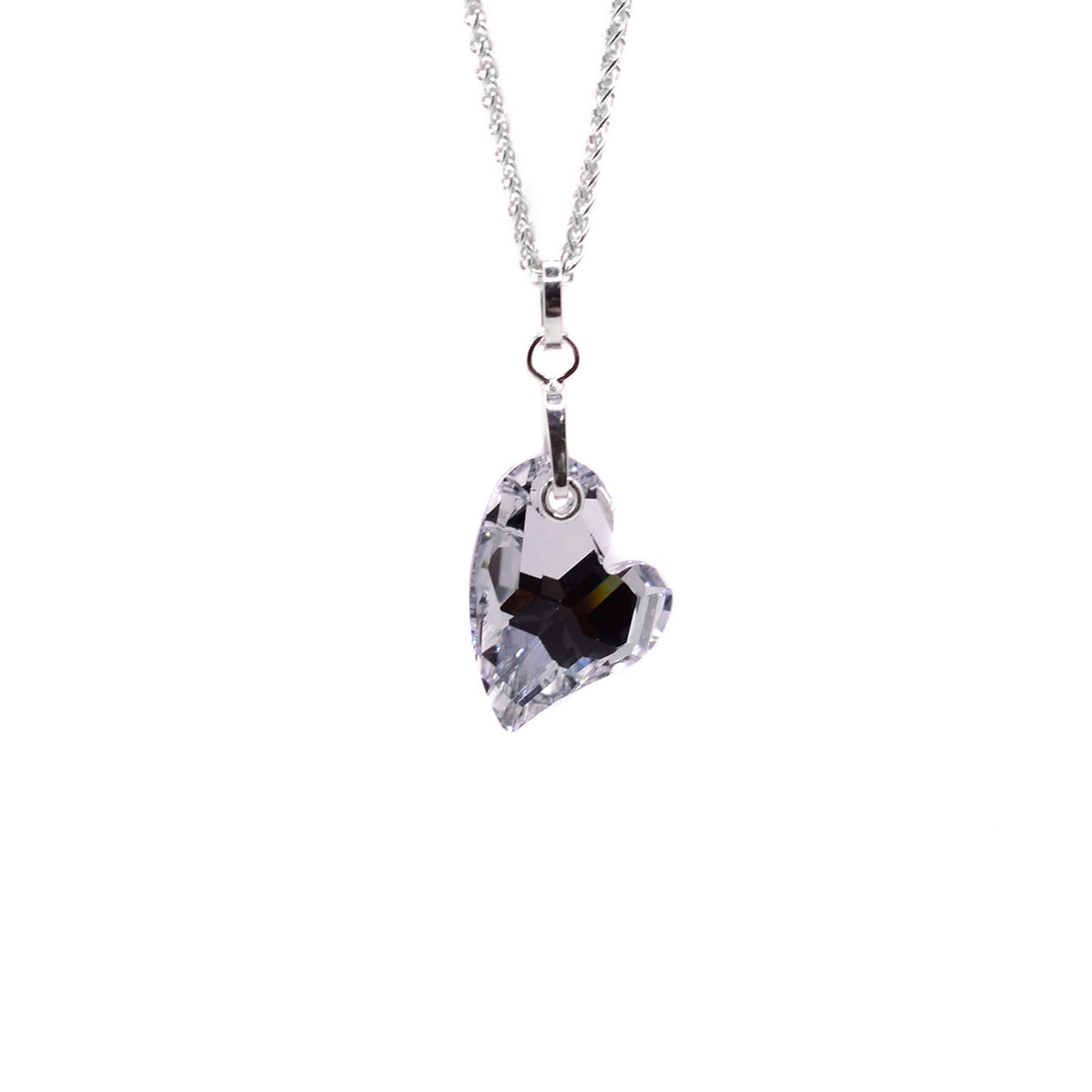 This crystal heart pendant is shaped like an asymmetrical heart and is clear. It has a hole at the top for the silver bail to go through.