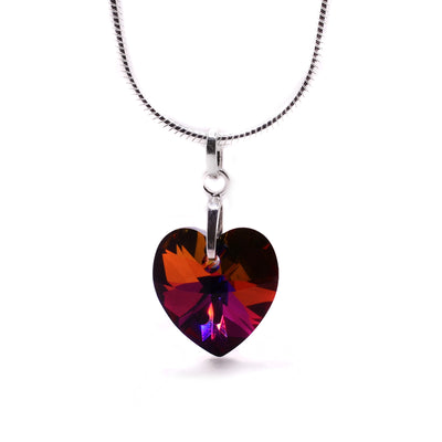 Volcano Swarovski Crystal Heart Pendant by Debra Nelson. The Swarovski crystal has been cut into a heart shape. The artist has put a small hole through the top of the heart to fit the bail through. The crystal has tones of red, orange, and pink.