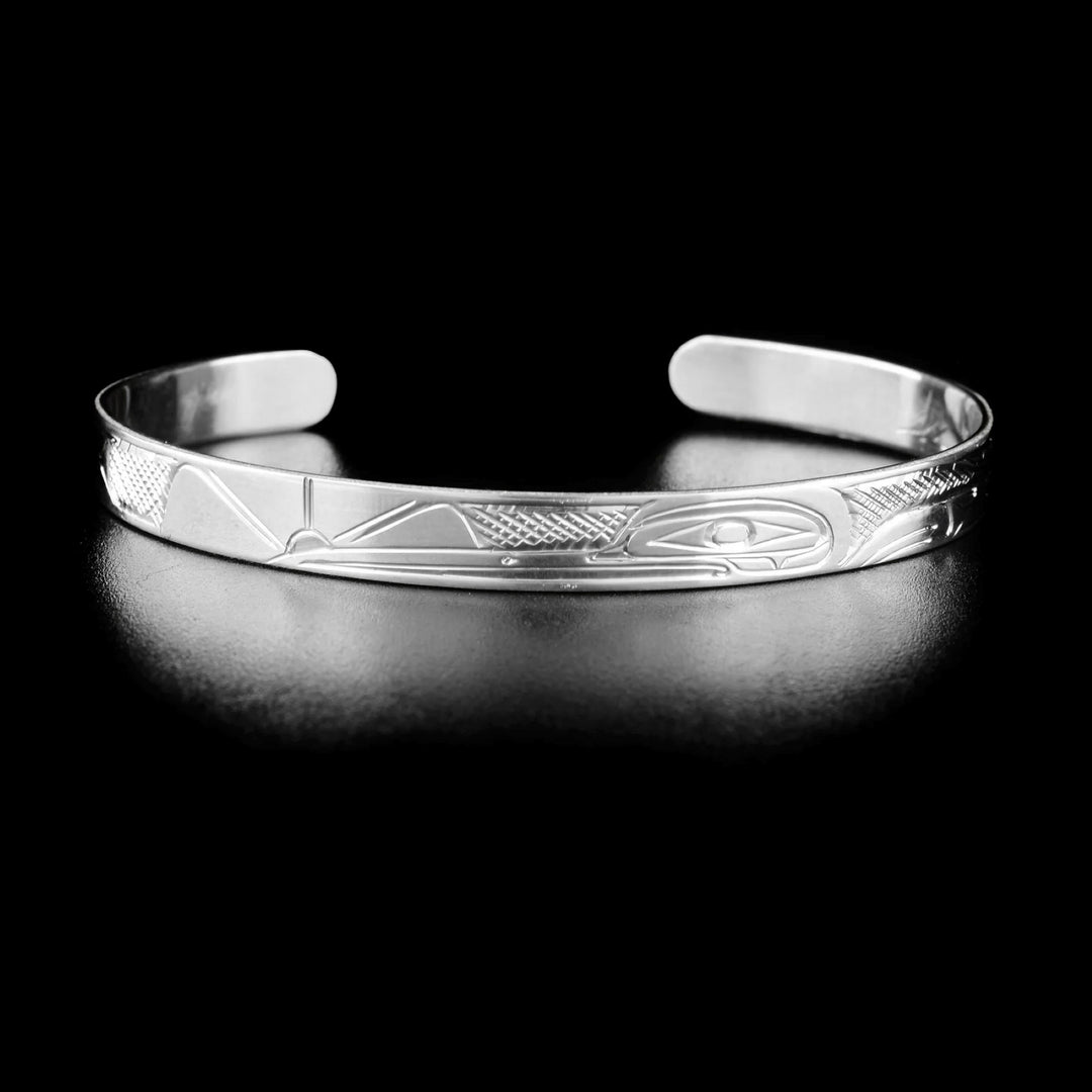 Delicate hummingbird bracelet hand-carved by Kwakwaka'wakw artist Don Lancaster. Made of sterling silver. Bracelet is 6.10" long with 1" gap and has width of 0.25".