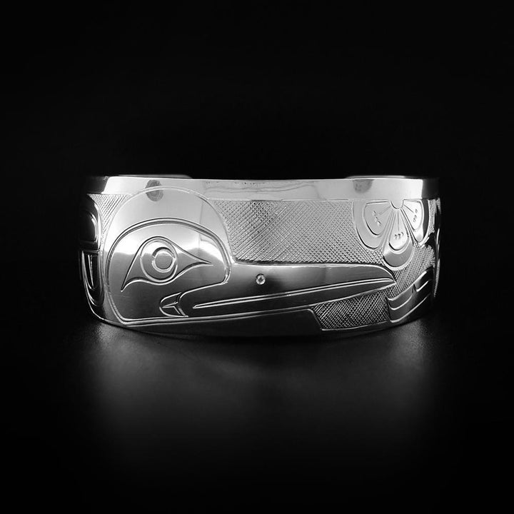 A sterling silver 1" Hummingbird bracelet with flowers. It depicts the face and wing of the Hummingbird.