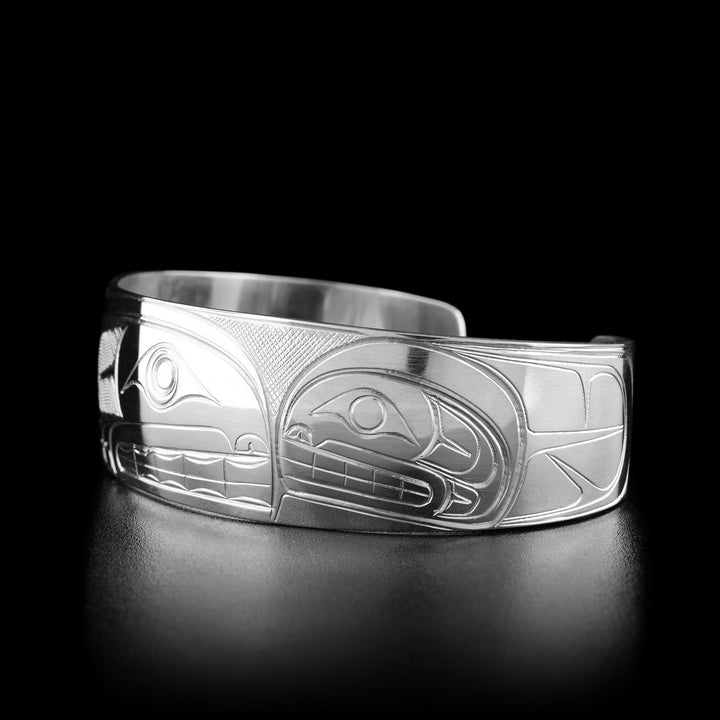 Right angle photo of the bracelet shows the head of a third orca facing towards the center with its body behind it.