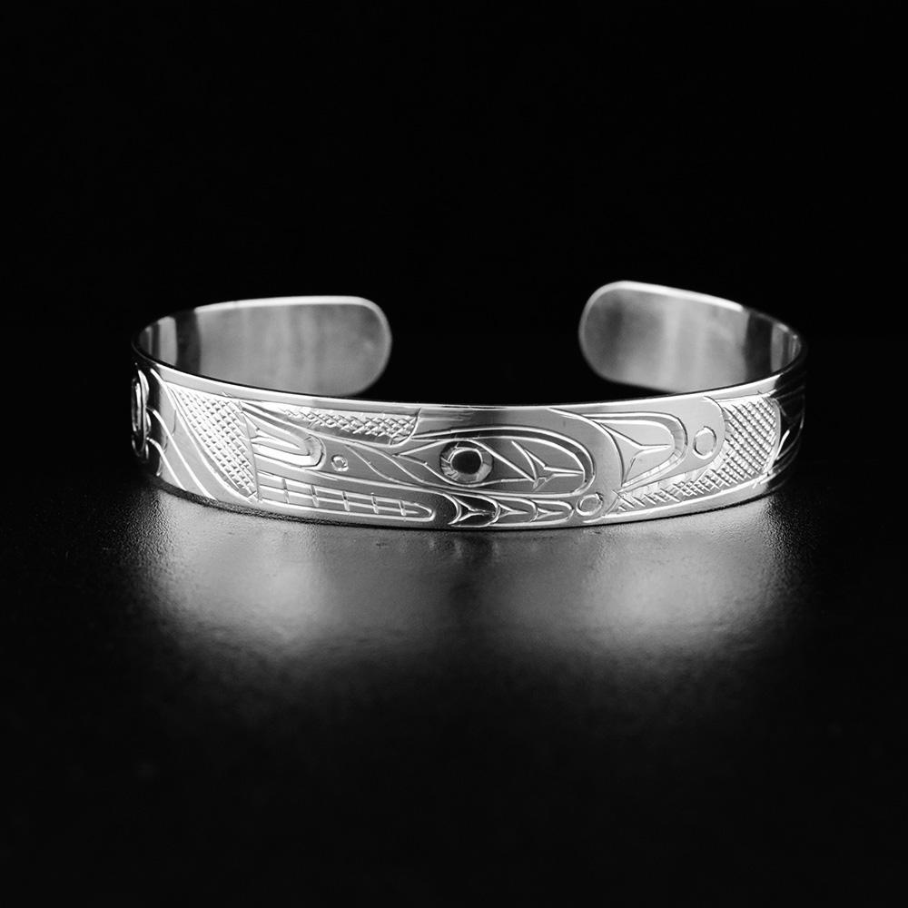 This Wolf bracelet is made from sterling silver and has a thin band with a gap in the back. There is a depiction of the Wolf carved into the surface of the band.