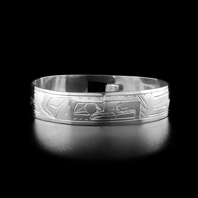 Sterling Silver 1/2" Eagle Clasp Bracelet by Gilbert Pat. The design depicts the profile of an eagle's head facing the right in the center of the bracelet. Both sides of the bracelet are delicately hand carved into the  wings of the eagle.