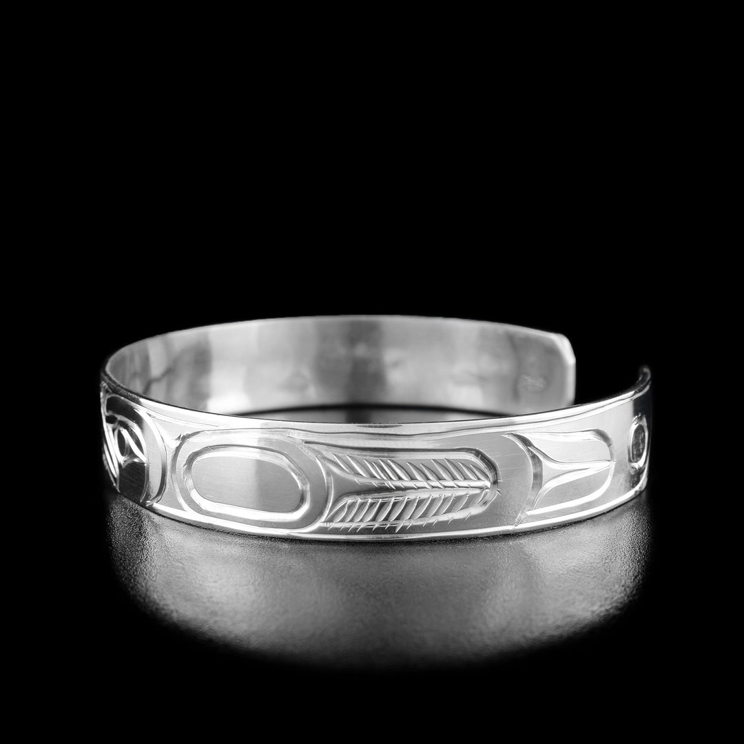 Right angle photo of the bracelet shows carved designs representing the eagle's body and wings.