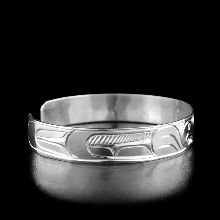 Left angle photo of the bracelet shows carved designs representing the eagle's feathers.