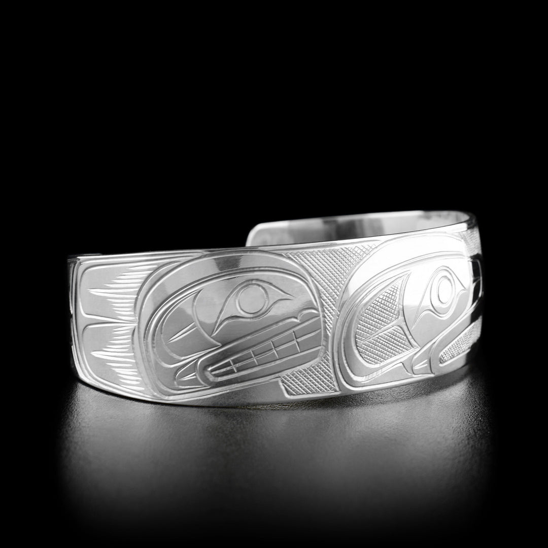 Left angle photo of the bracelet shows the profile of an orca's head facing towards the center.