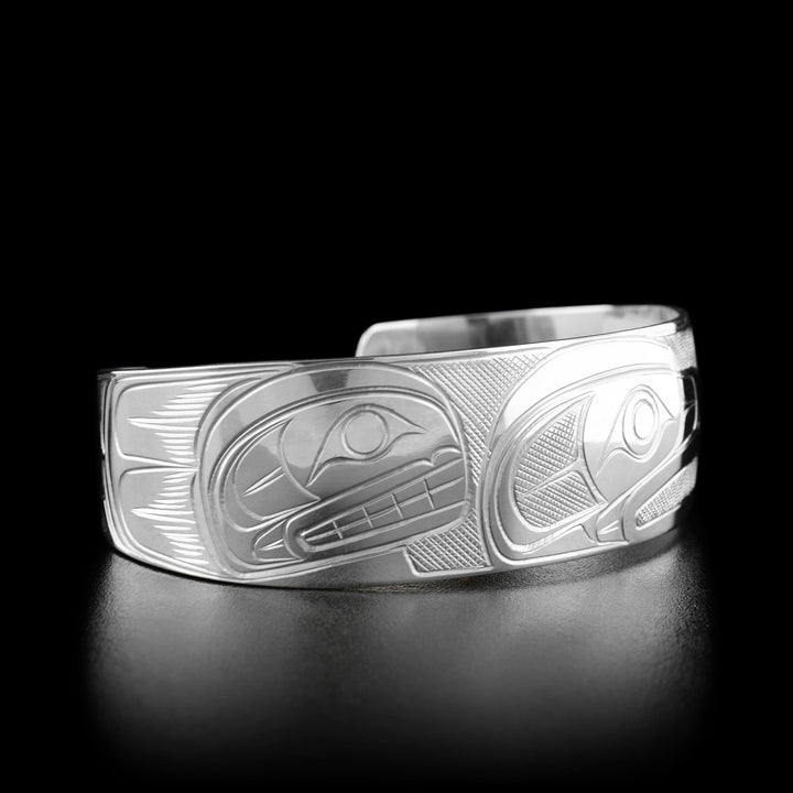 Left angle photo of the bracelet shows the profile of an orca's head facing towards the center.