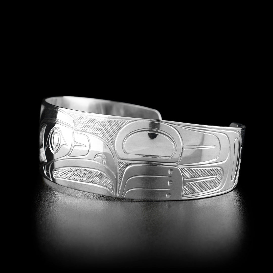 Right angle photo of the bracelet shows carved designs representing the wing of the eagle.