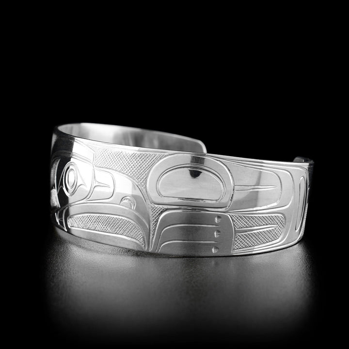 Right angle photo of the bracelet shows carved designs representing the wing of the eagle.