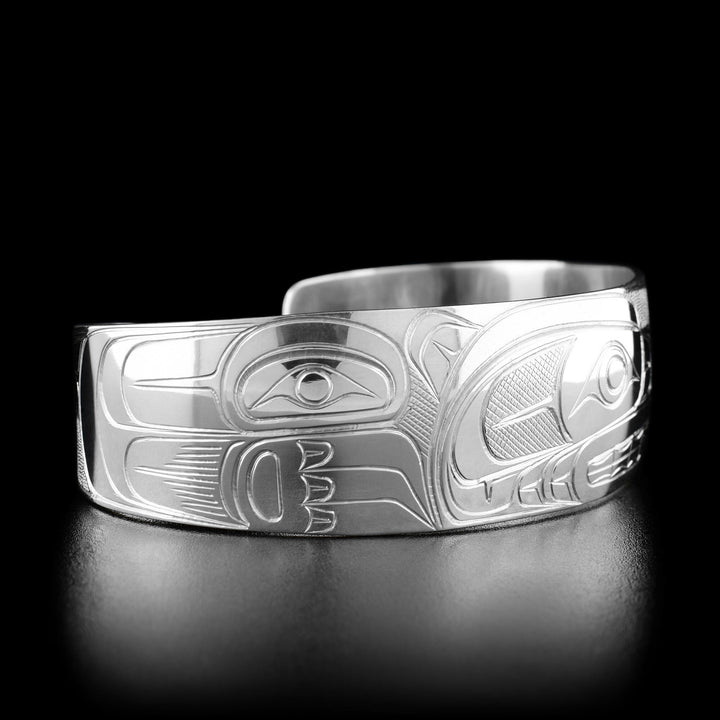 Left angle photo of the bracelet shows carved designs representing the body of the bear.