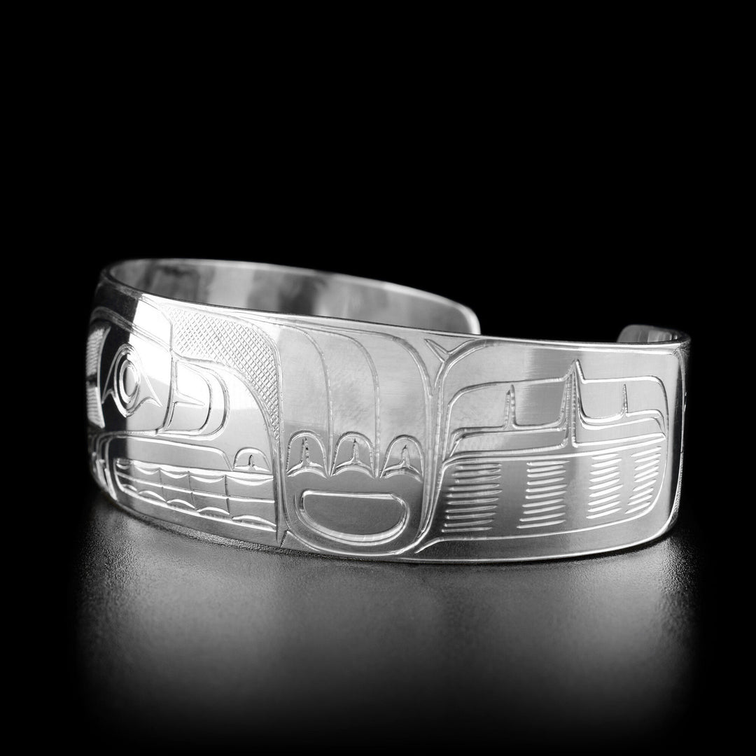 Right angle photo of the bracelet shows carved designs representing the fur of the bear.