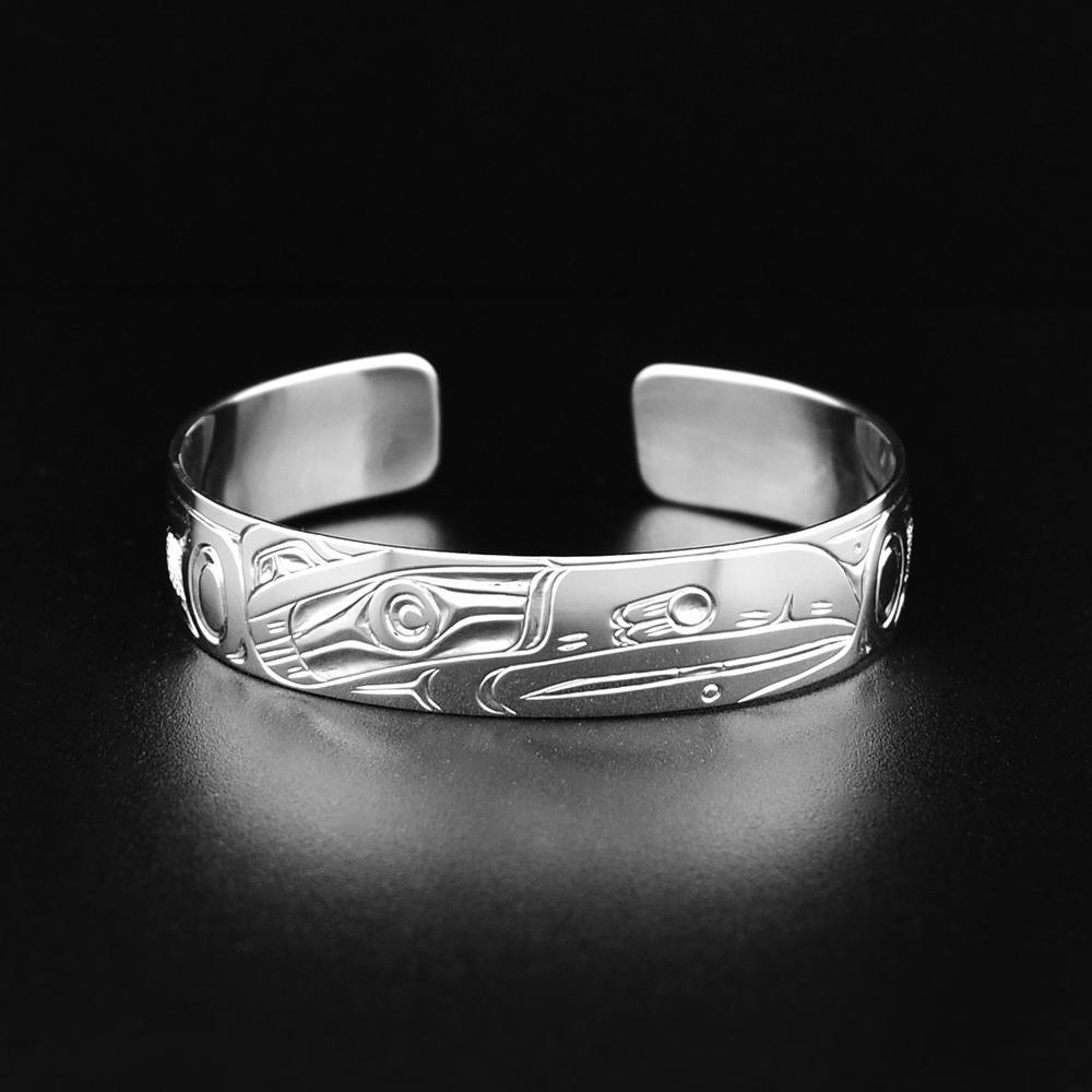 This Raven bracelet is made from sterling silver and has a single band. There are deep carvings on the surface of the band that depict the Raven.