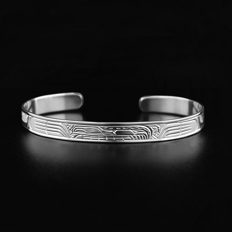 This Bear bracelet cuff has a single, thin and sterling silver band that has a gap in the back. There is a depiction of the Bear carved into the surface of the band.