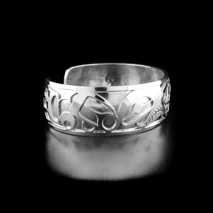 Left angle photo of the bracelet shows carved designs representing the body and wing of the first hummingbird.