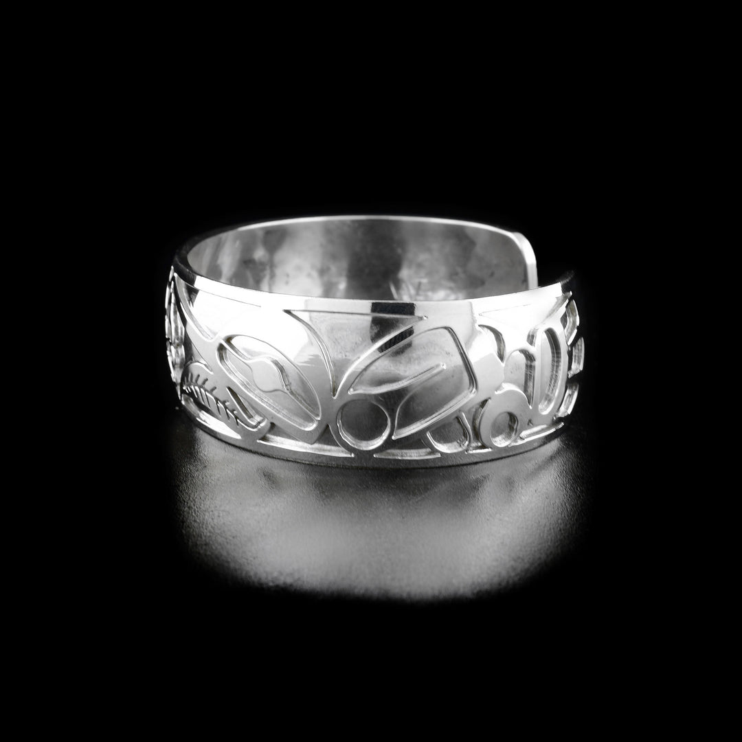 Right angle photo of the bracelet shows carved designs representing the body and wing of the second hummingbird.