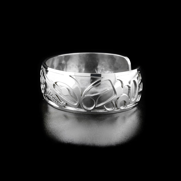 Right angle photo of the bracelet shows carved designs representing the body and wing of the second hummingbird.