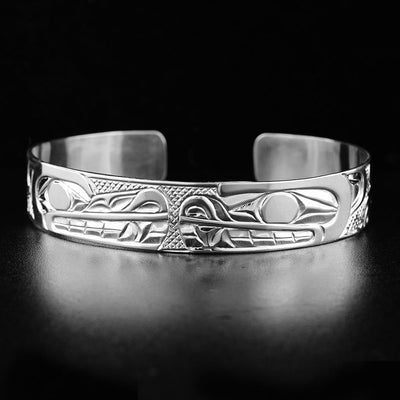 half inch sterling silver wolf and bear cuff bracelet is hand-carved by Carrie Matilpi.